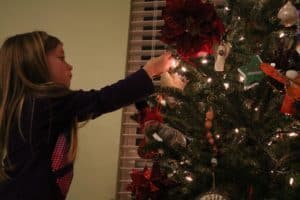  Girl decorating Christmas Tree